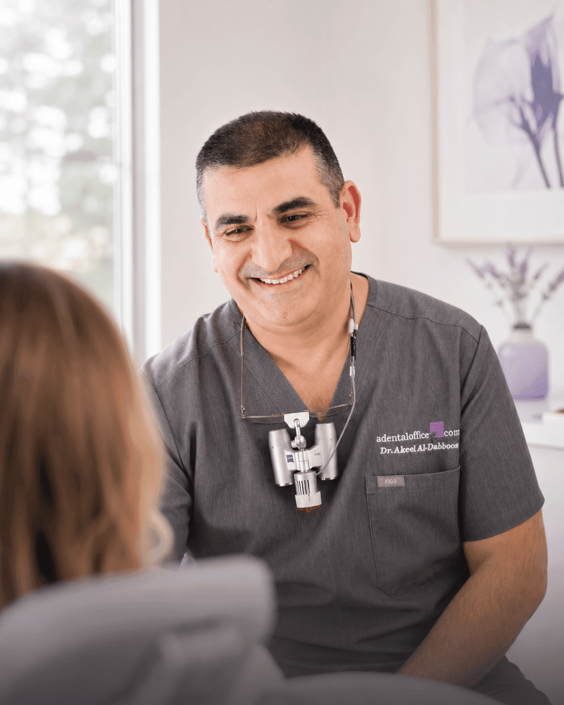 Dr. Akeel Al-Dabboos providing gentle dental care to a smiling patient at A Dental Office in Barrie, Ontario